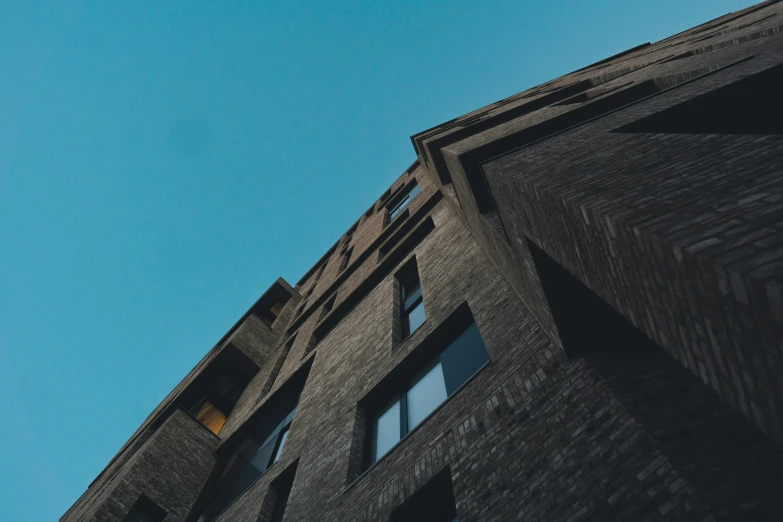 a building with the top of the roof raised in the sky