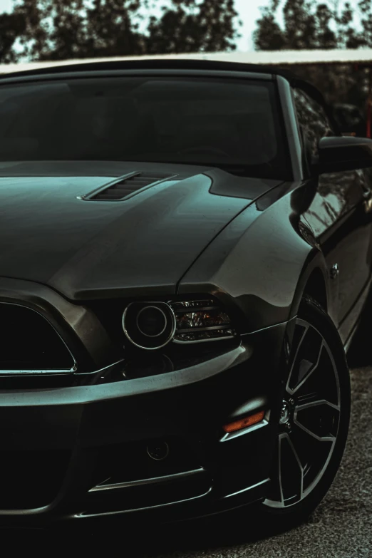 a very nice looking black mustang on the road