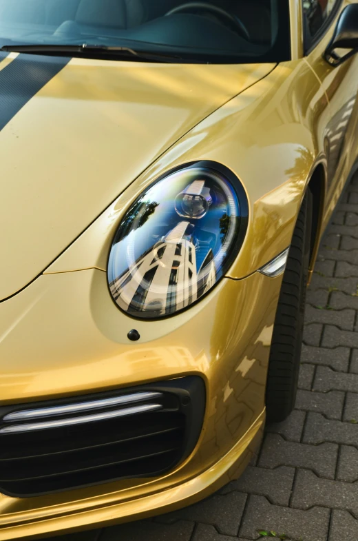 the front of a yellow sports car with a unique front grille and logo