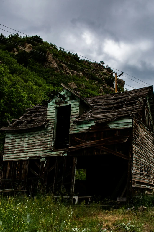 the wooden house on the hill looks old