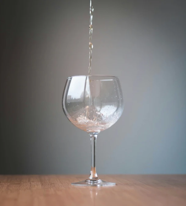 a wine glass filled with water and bubbles