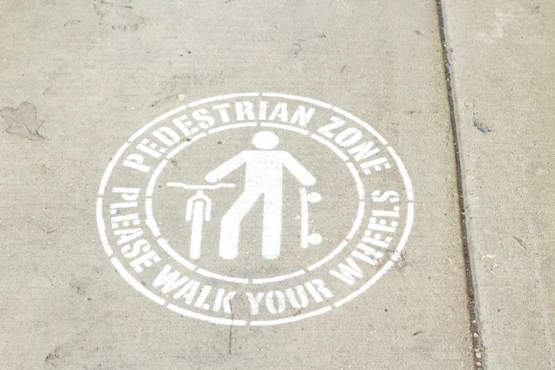 a sidewalk with a white stamp of a man carrying a backpack