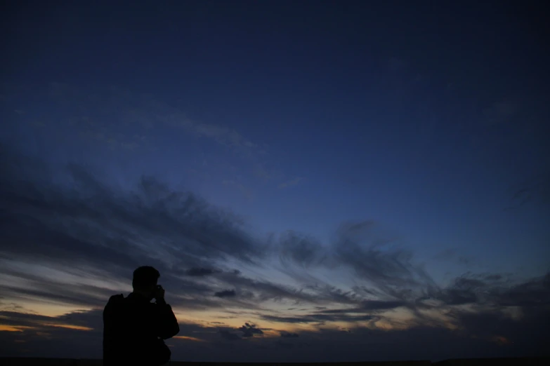 the person is standing on the sand under an overcast sky