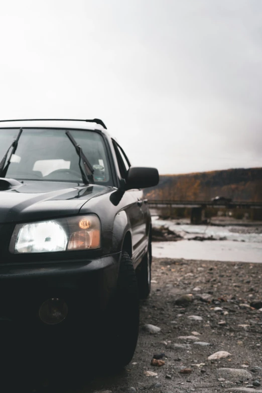 a car is parked next to the rocks