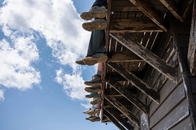 shoes are lined up on the roof of a small hut