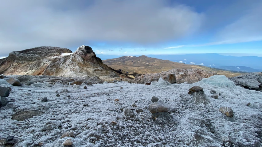 snow covered rocks and ground on the mountain