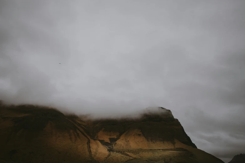 a person is hiking up a hill with a backpack