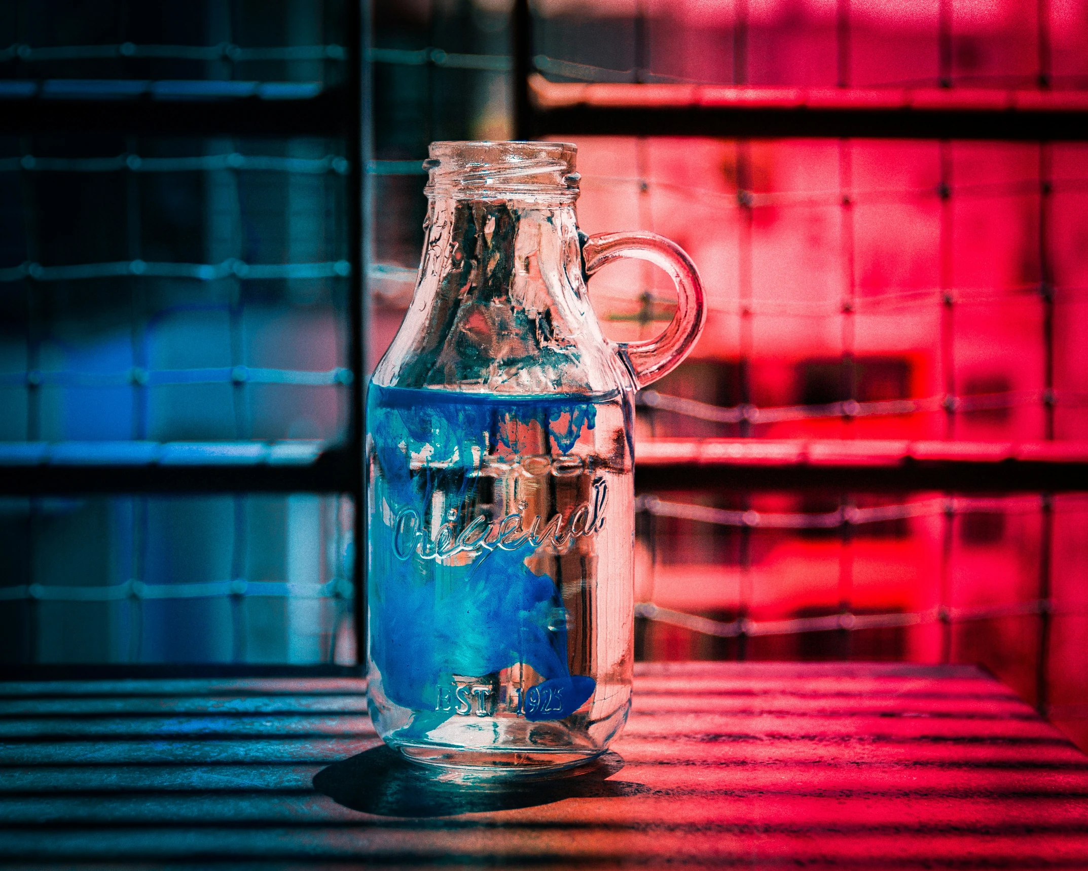 the blue and green liquid in a glass bottle