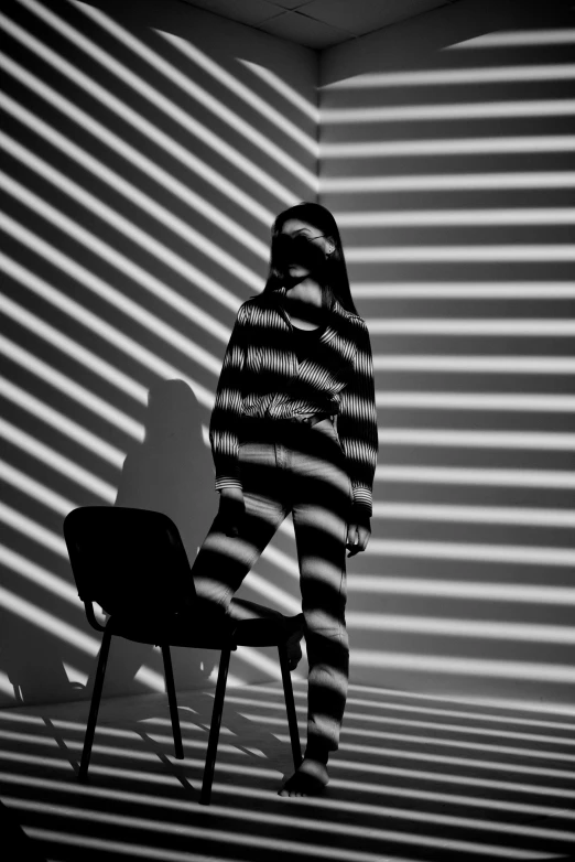 a person in a room with the shadows of walls