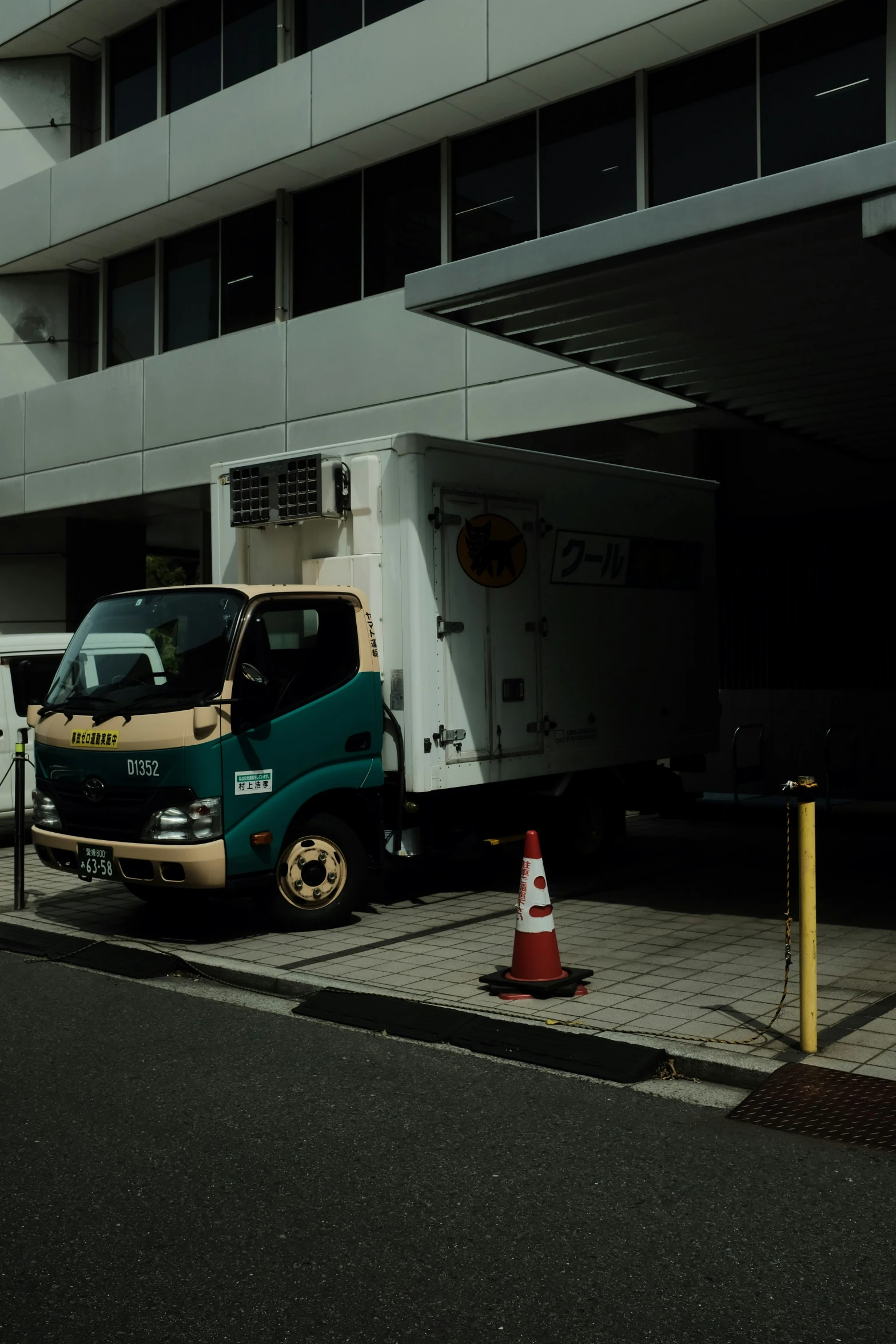 a truck parked next to a tall building