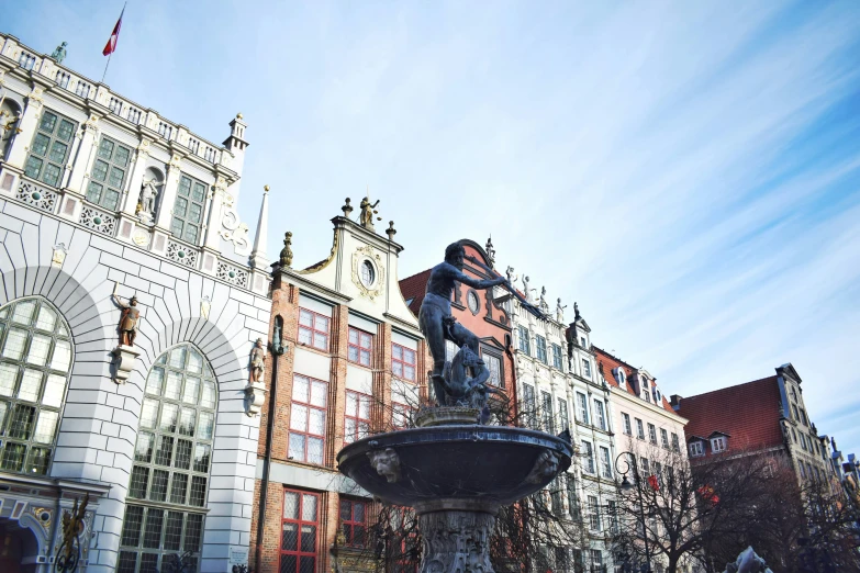 an old fountain in front of several buildings