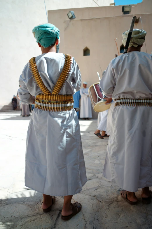 two people in white and gold clothing