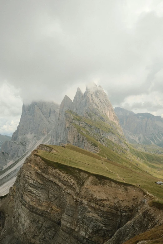 a mountain is covered in green grass and bushes