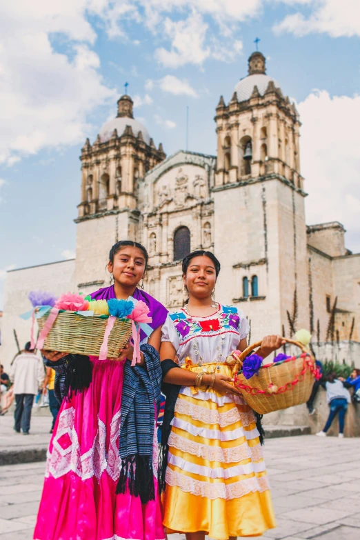 two women standing near each other with some flowers in their hands