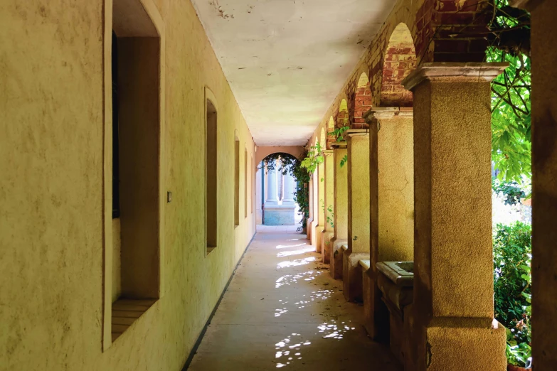 a narrow hallway leads to an outdoor courtyard