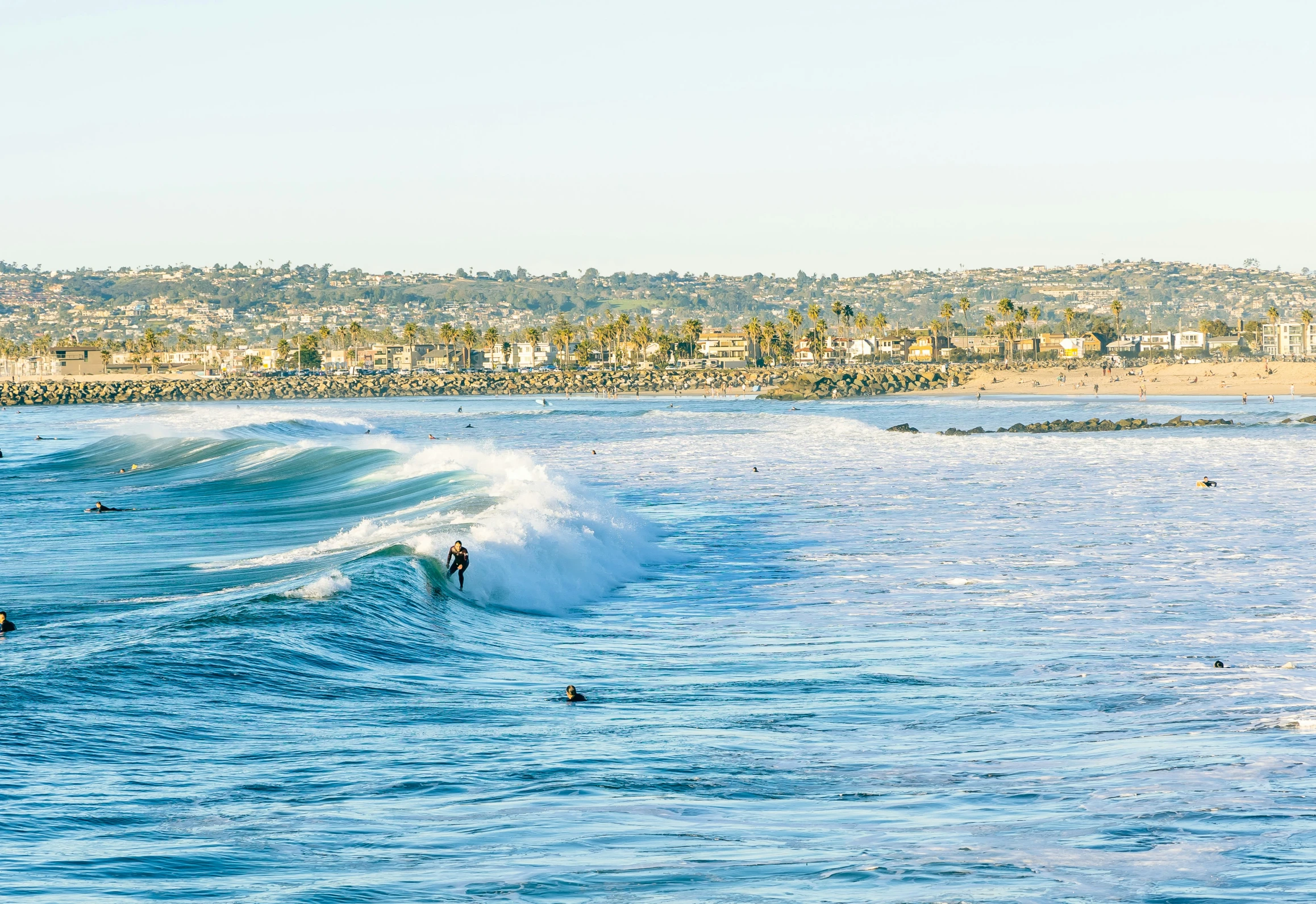 the surfers are riding their boards in the water