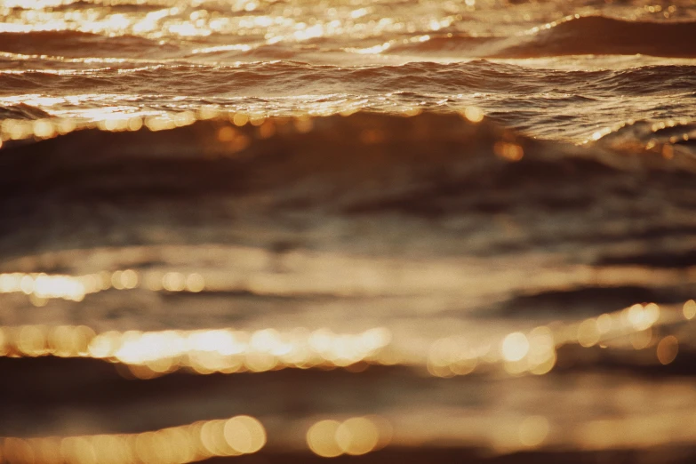 a blurry po of a wave with light reflected on it