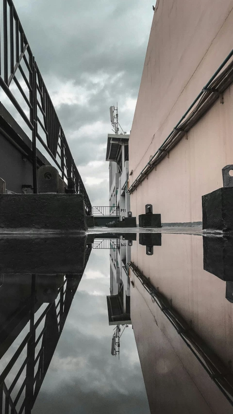 a boat dock and another body of water with clouds