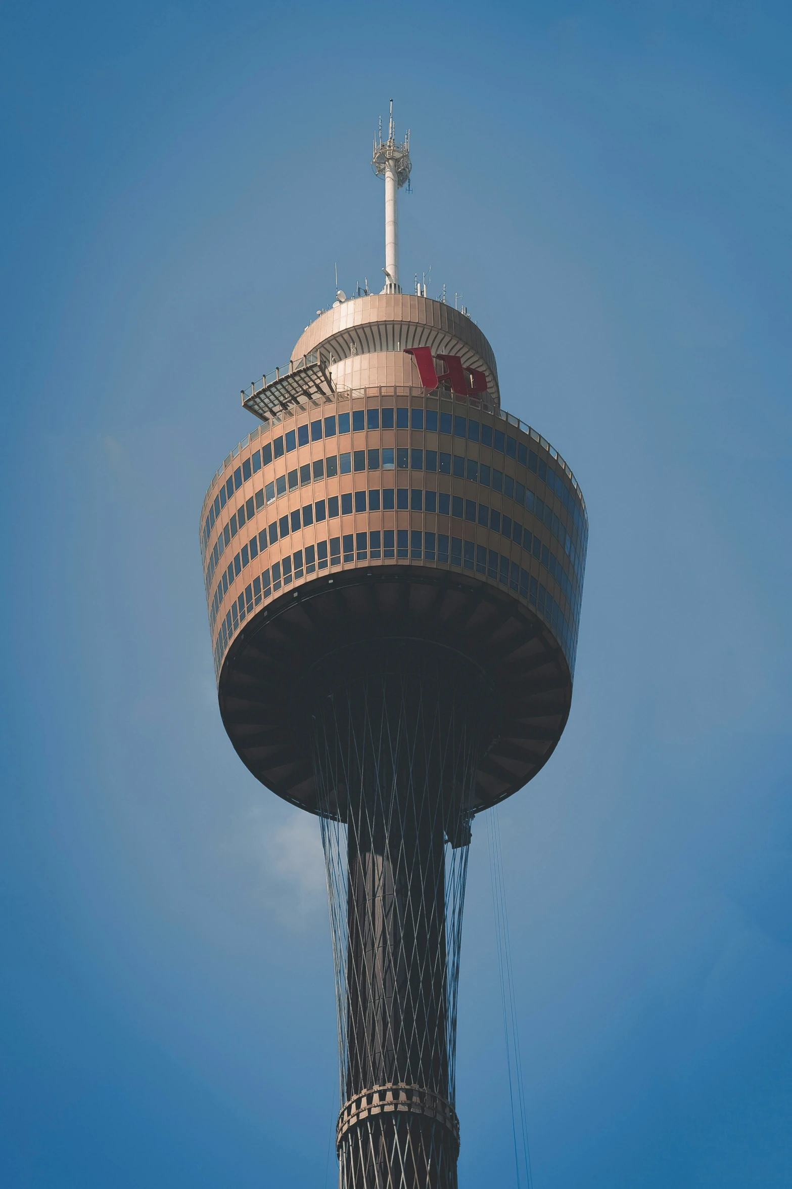 an upside down view of a tower against a clear blue sky