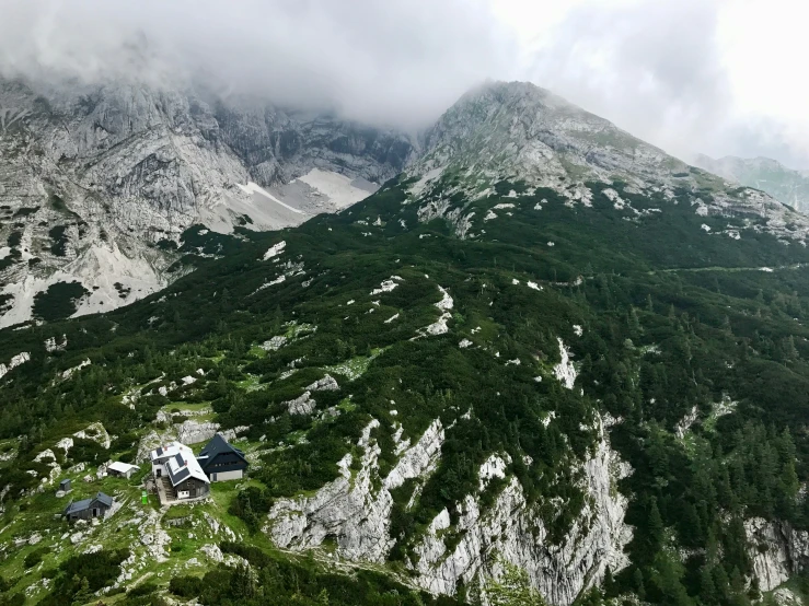 the house is near the mountain in the clouds