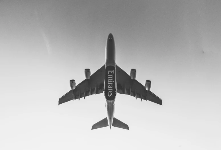 an airplane flying through a clear sky and clouds