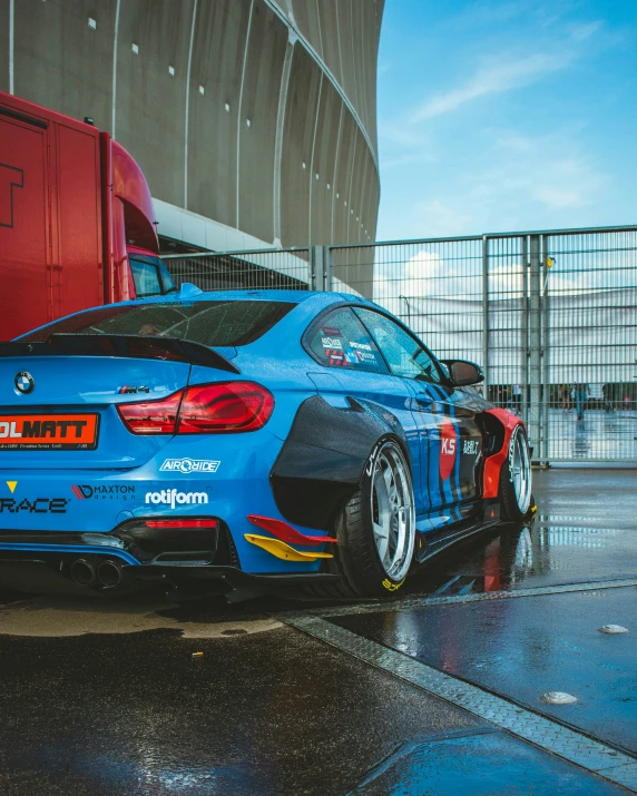 a blue bmw with orange details on its body