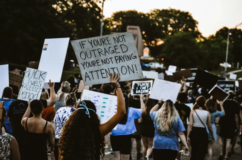 a bunch of women holding up signs at a protest