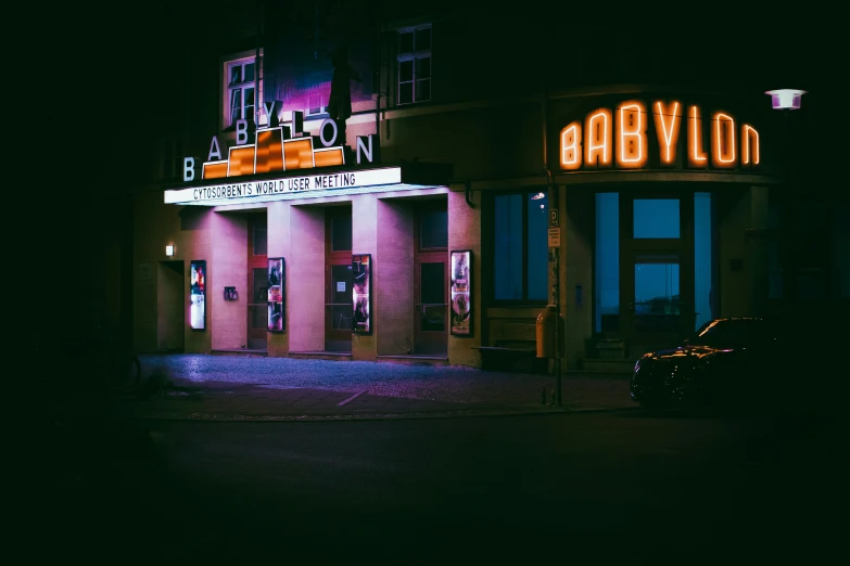 the exterior of an theatre is lit up