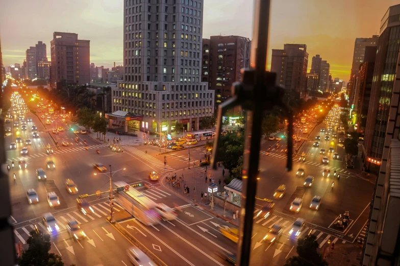 a city with tall buildings at sunset and light traffic