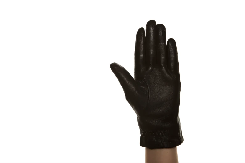 the left hand of an adult wearing a black glove