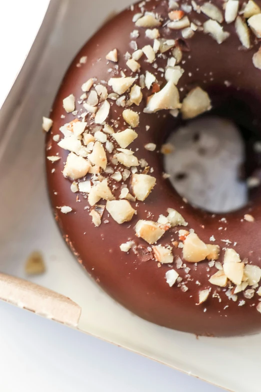 this doughnut has a small amount of nuts around it