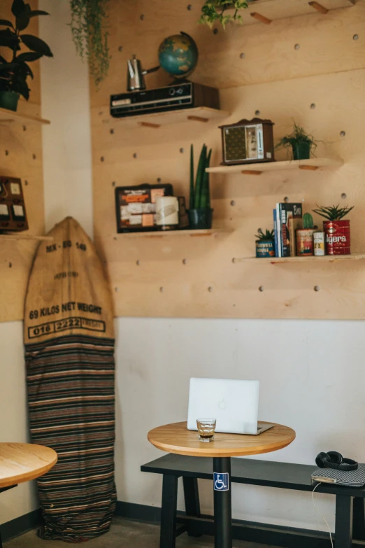 a surfboard on display in front of a wooden table