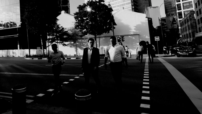 men in shirt and tie crossing the street in the city