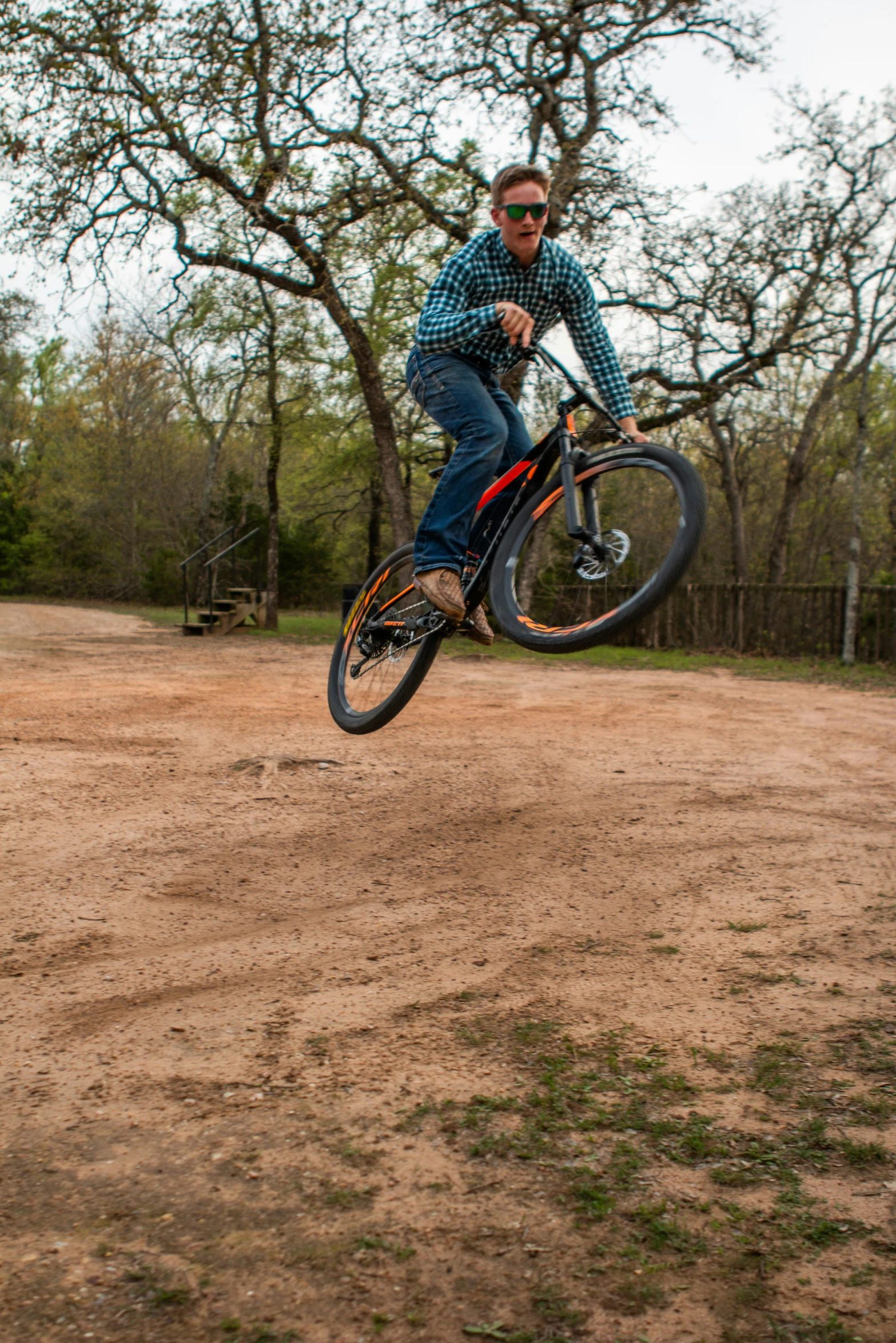 the young man is riding a bike outside