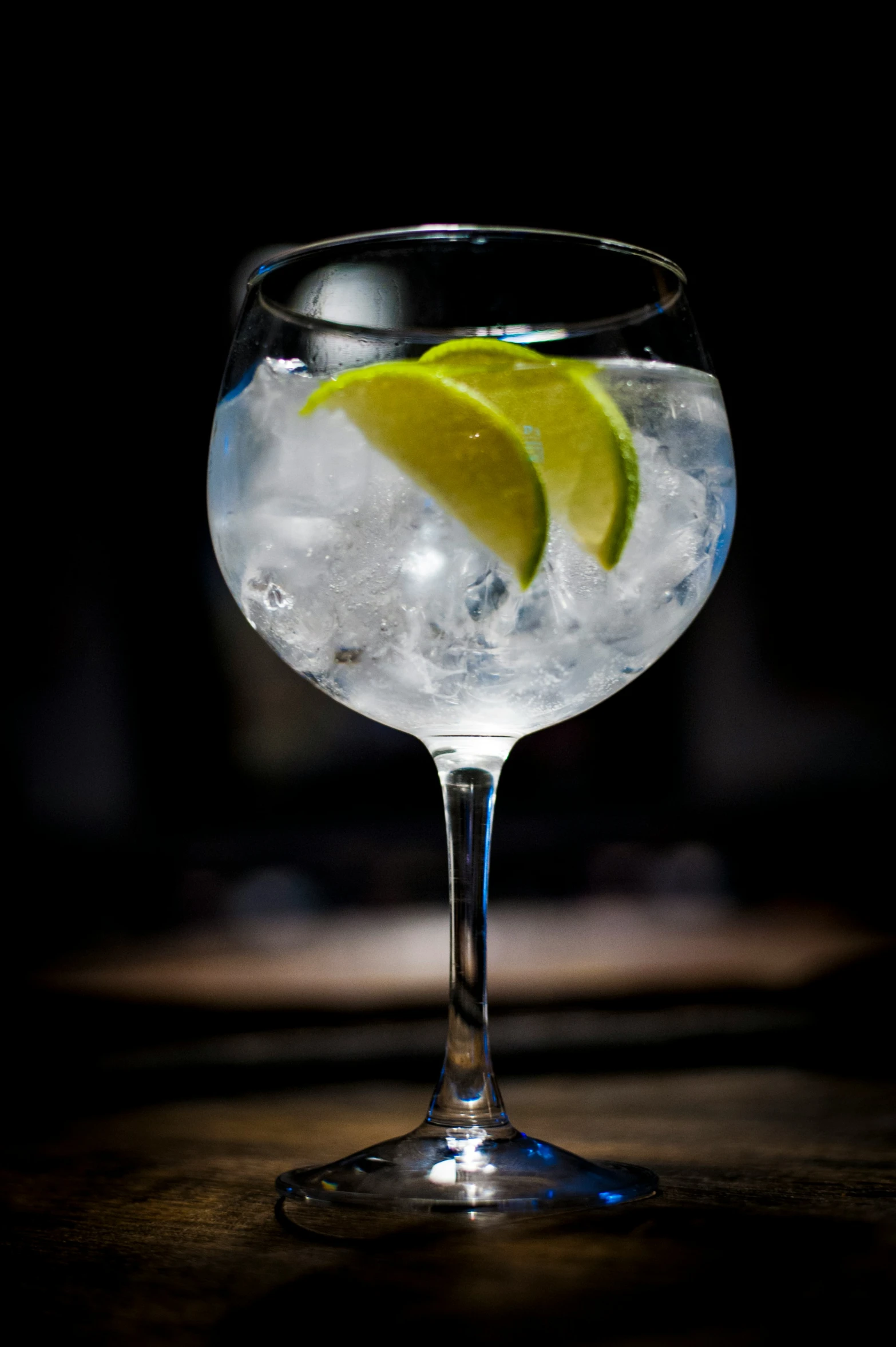 a glass filled with a drink and a slice of lemon