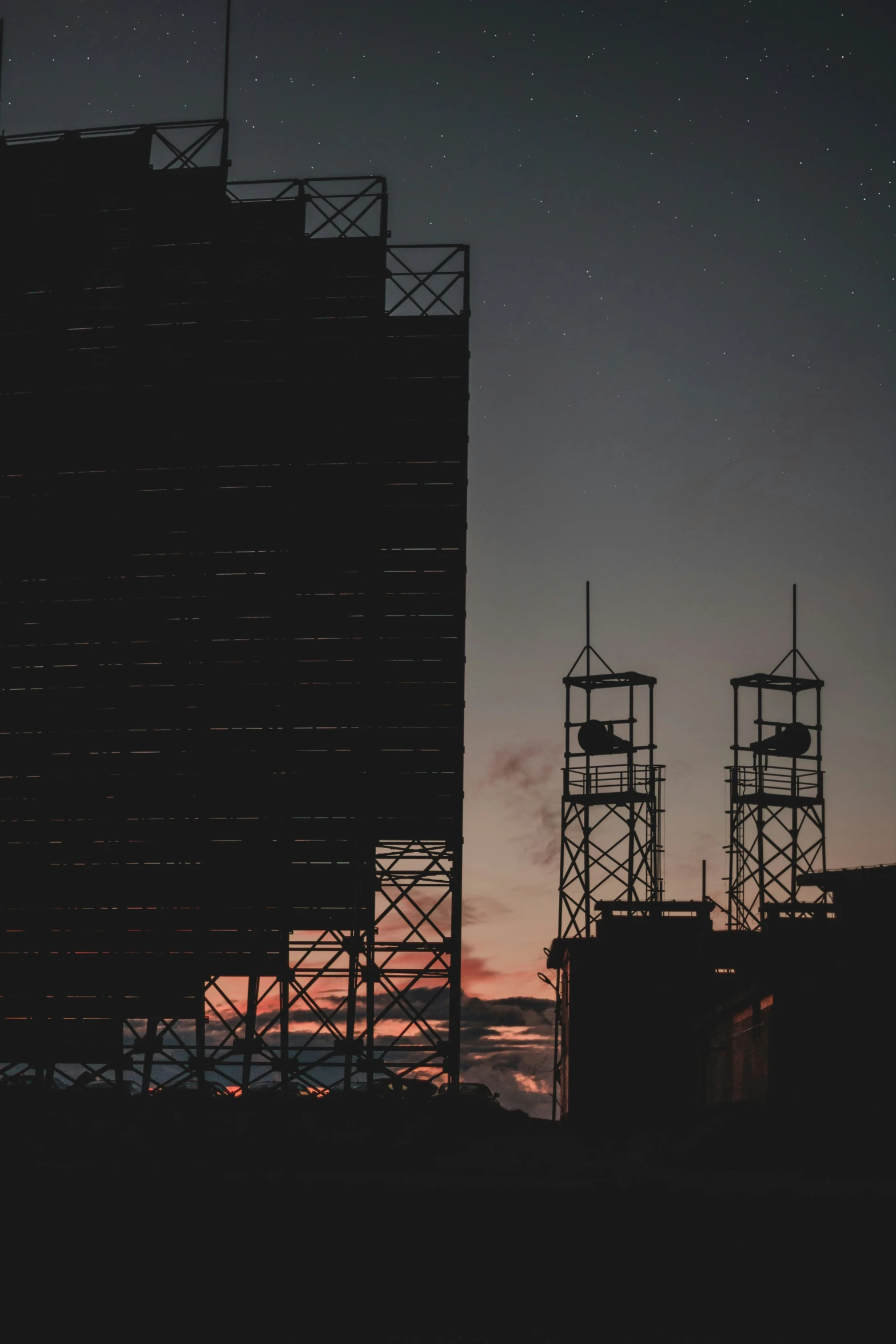 some buildings in the dark at night