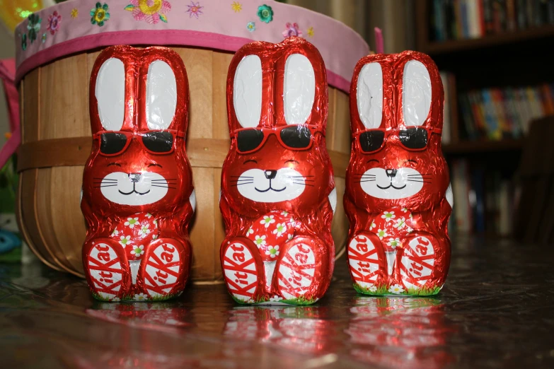 some little chocolate rabbits on top of a wooden table