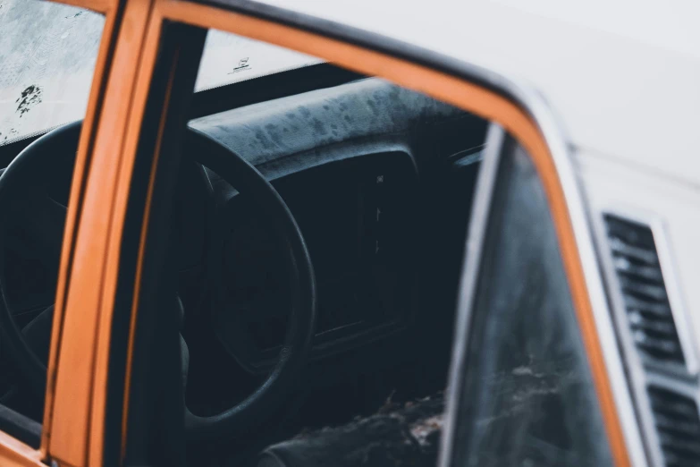 orange truck door is shown with interior and dash board