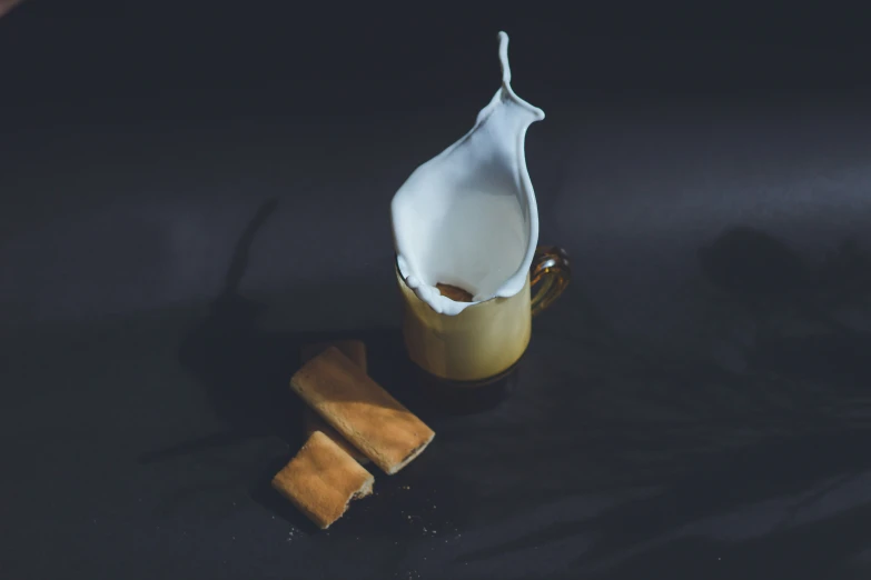 a close up of a glass on a table with a cup