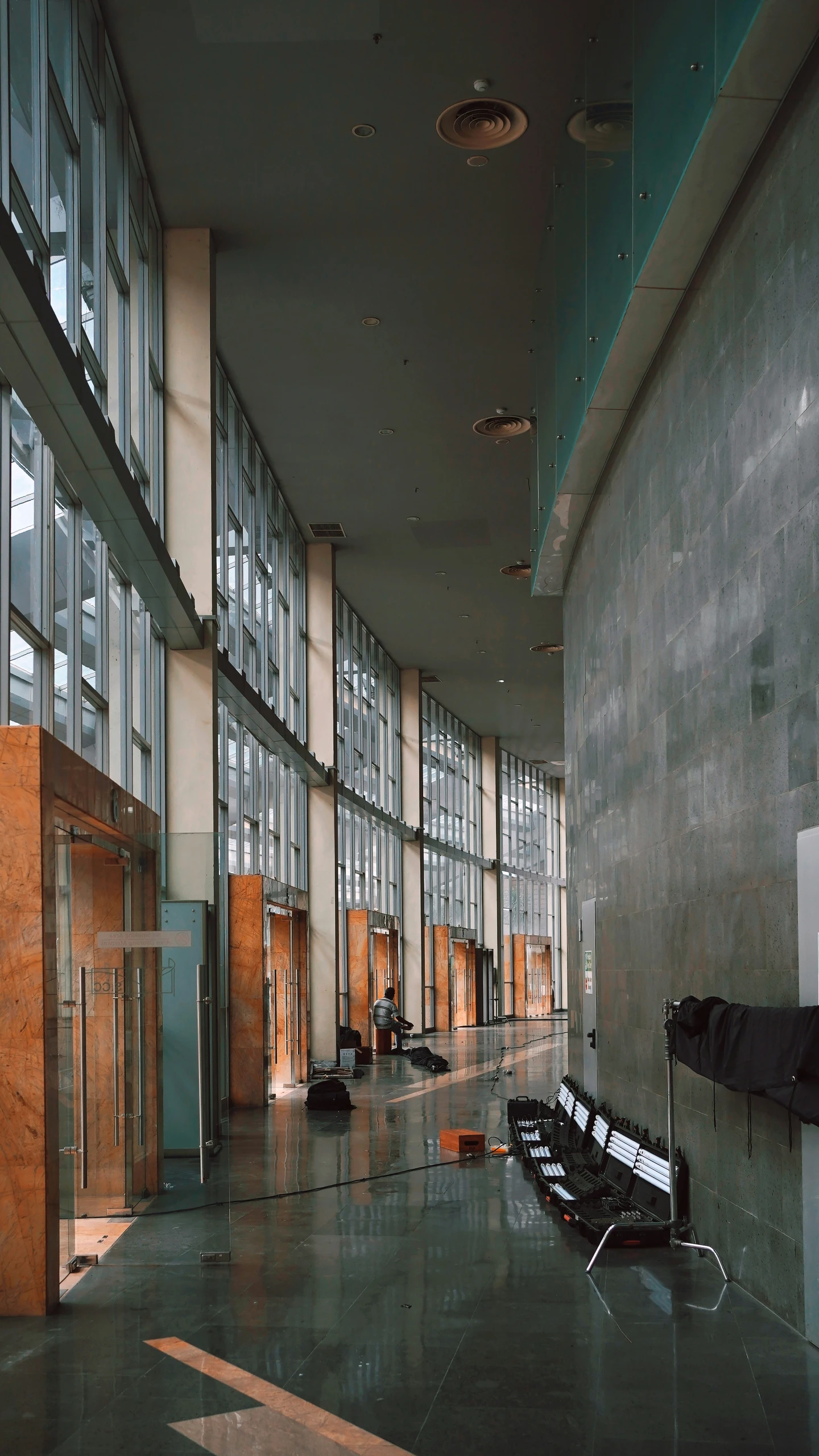 an airport lobby with luggage and chairs and windows