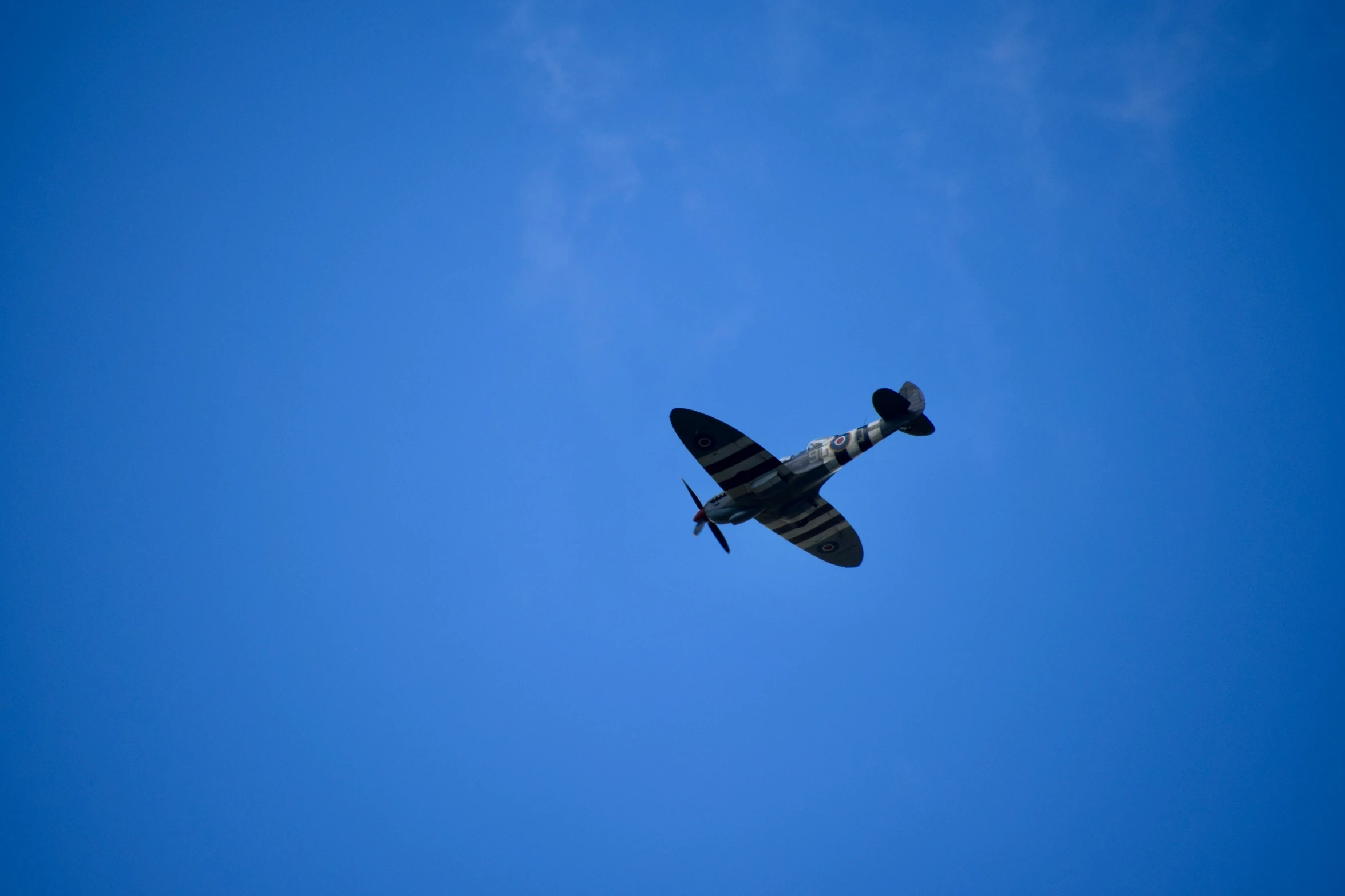 the biplane is flying high in the sky