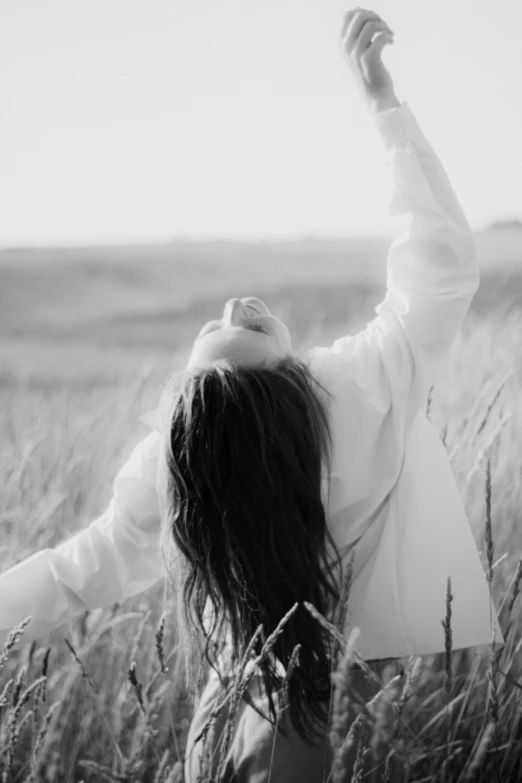 a woman with her arms in the air above her head