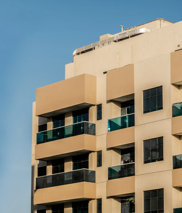 a building with balconies and some green railings