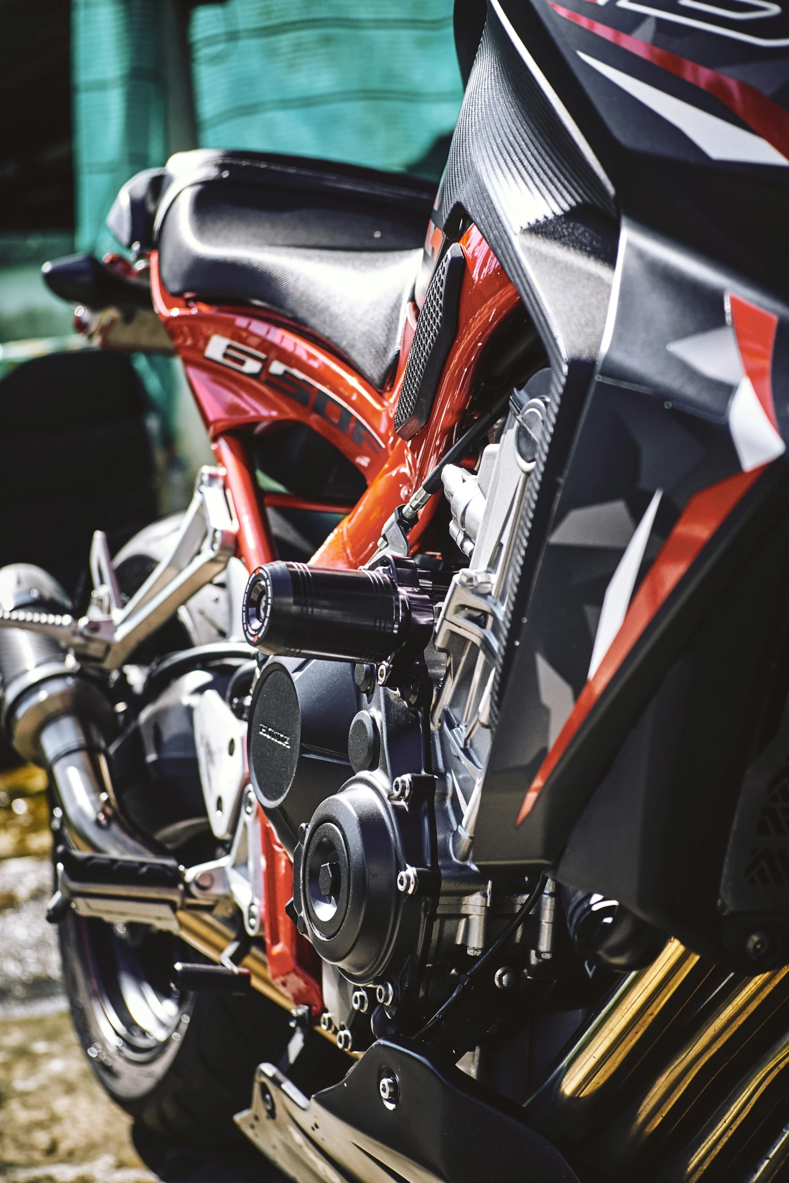 two parked red motorcycles and one black motorcycle