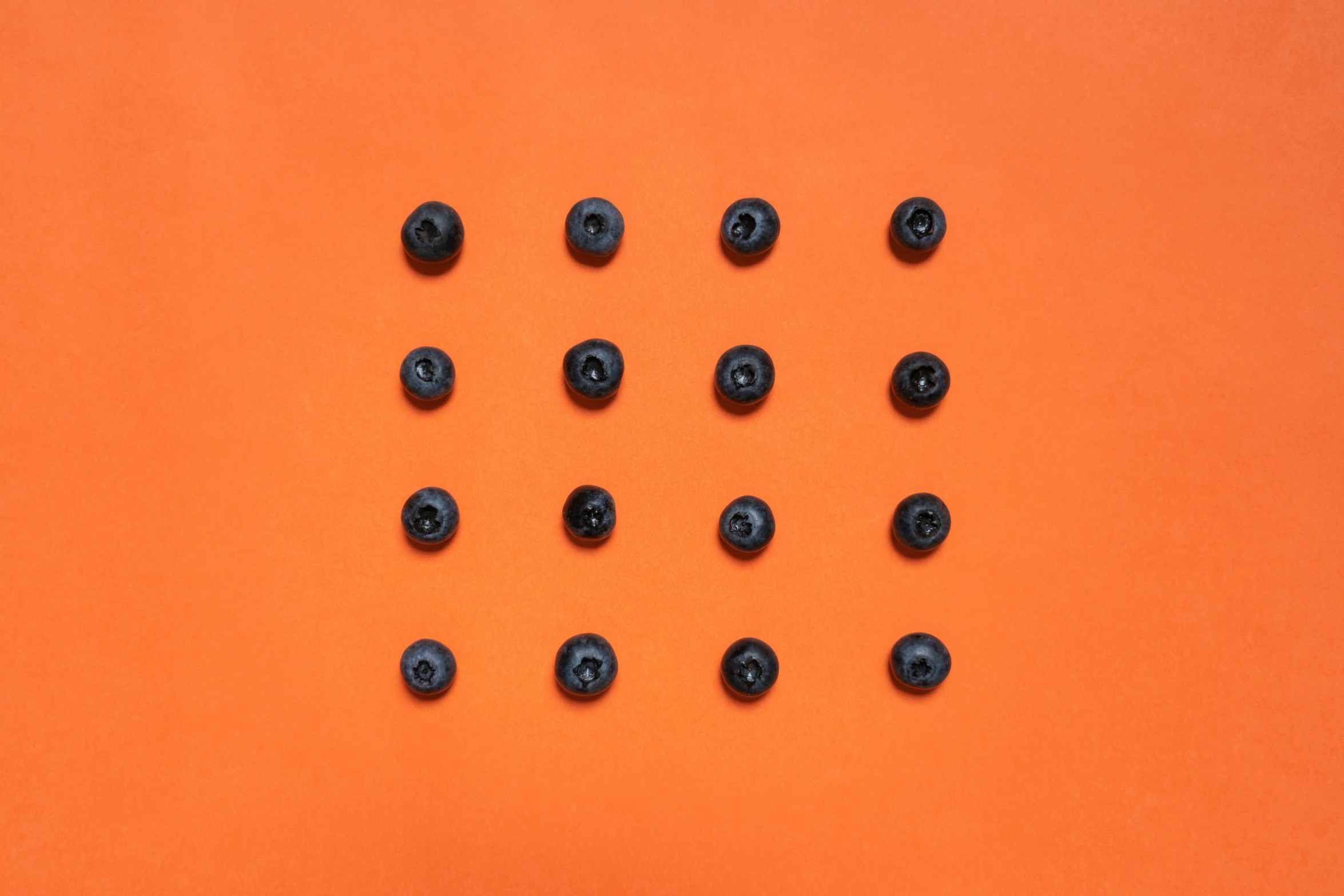 a bunch of black ons on an orange background