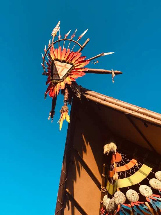 a decorative item sits against the blue sky