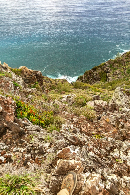 the view from a very high rocky hill of a beautiful sea