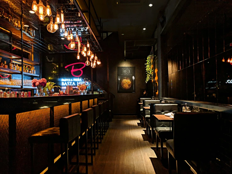 a dimly lit restaurant with lots of chairs