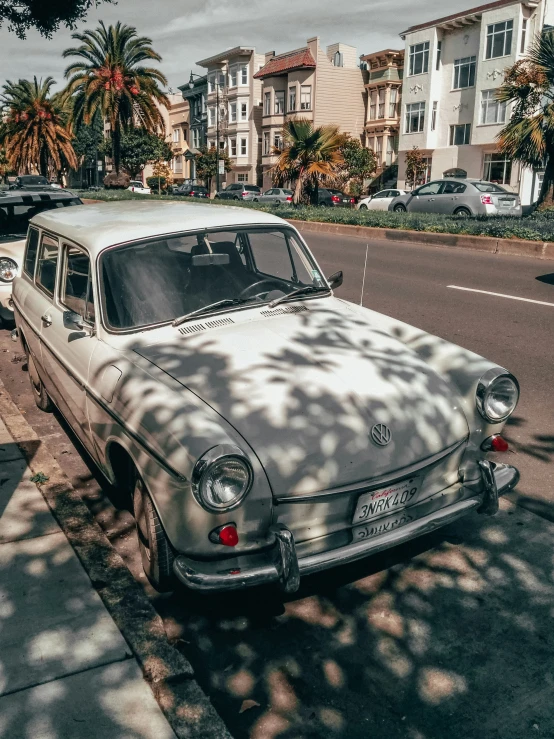 a classic car parked in front of a building