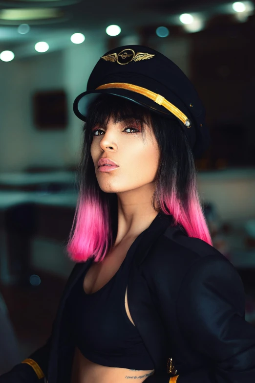 a woman with pink hair wearing a hat